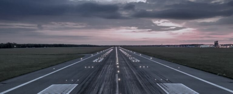 Runway at dusk with centerline lights stretching forward, symbolizing readiness for takeoff before movement begins